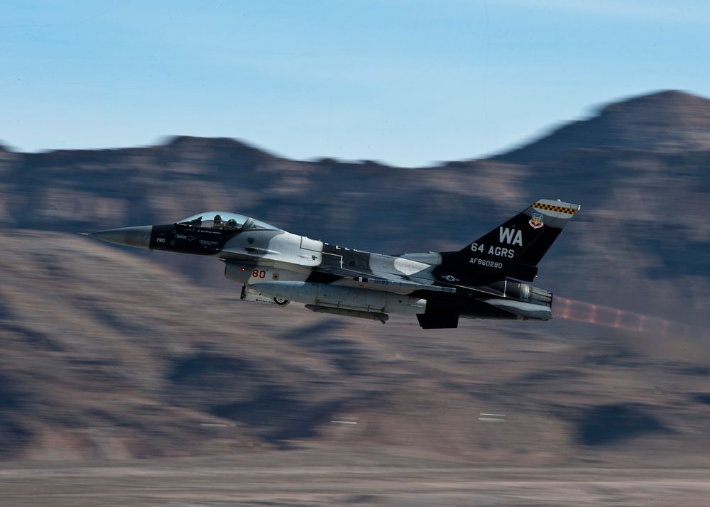 A U.S. Air Force F-16 Fighting Falcon aircraft attached to the 64th Aggressor Squadron takes off during Red Flag 14-1 at…