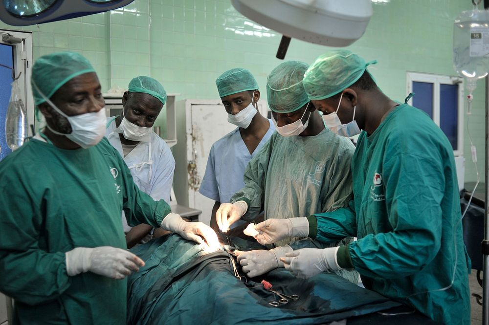 Surgeons stitch up a patient after an operation at Banadir hospital in Mogadishu, Somalia, on February 4. AU UN IST PHOTO /…