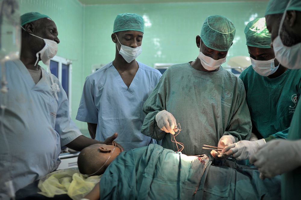 Surgeons stitch up a patient after an operation at Banadir hospital in Mogadishu, Somalia, on February 4. AU UN IST PHOTO /…