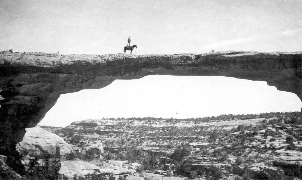 Natural Bridges National Monument in Utah. Dan Perkins standing on his horse "Cap" on top of Owachomo Bridge. Original…