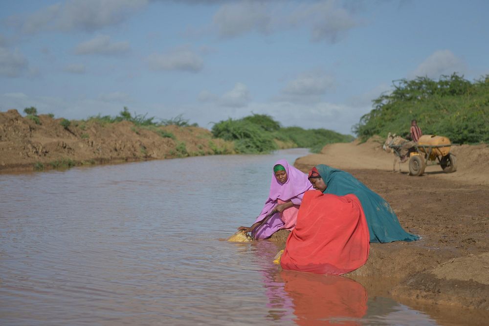 Women fill jerry cans full of water from the river on April 29 in Qoryooley, Somalia, just over one month after the town was…