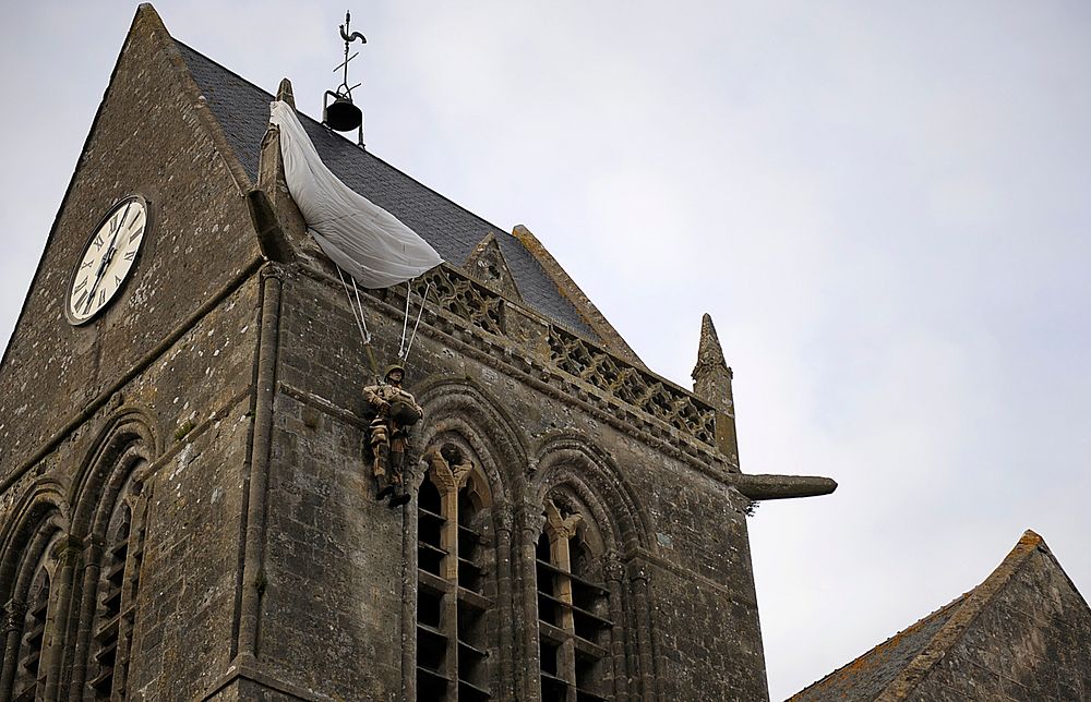 A simulated U.S. Army paratrooper hangs from the infamous church in Sainte-Mère-Église, Normandy, France, June 3, 2014.