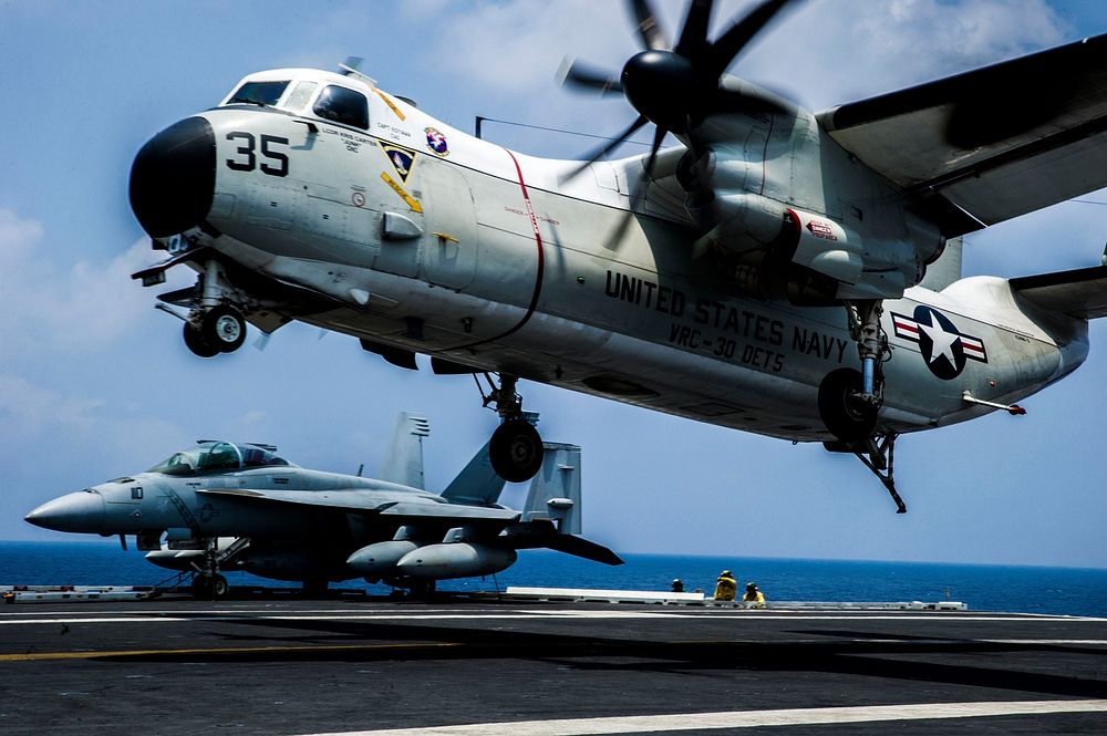 A U.S. Navy C-2A Greyhound aircraft assigned to Fleet Logistics Support Squadron (VRC) 30 prepares to land aboard the…