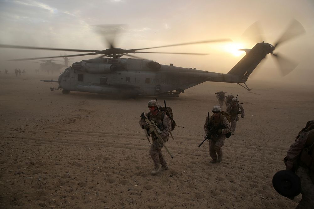 U.S. Marines with Bravo Company, 1st Battalion, 7th Marine Regiment run to security positions after exiting a CH-53E Super…