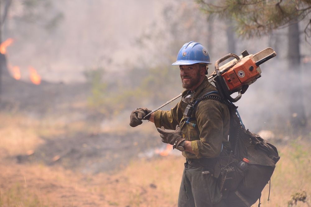 A firefighter takes a break before moving along the fire line near Madras, Ore., July 21, 2014.