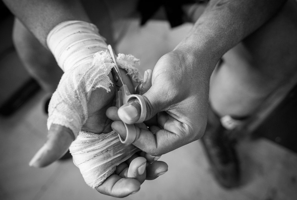Stephon “The Surgeon” Morris cuts off his hand wraps after his boxing session at UMAR Boxing Gym Baltimore, Md., June 18…