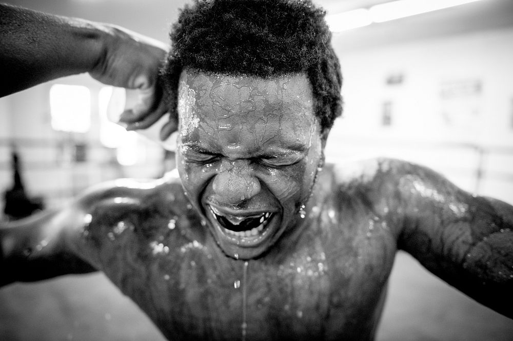 Water pours down the face of Stephon “The Surgeon” Morris during a sparring session at UMAR Boxing Gym Baltimore, Md., June…