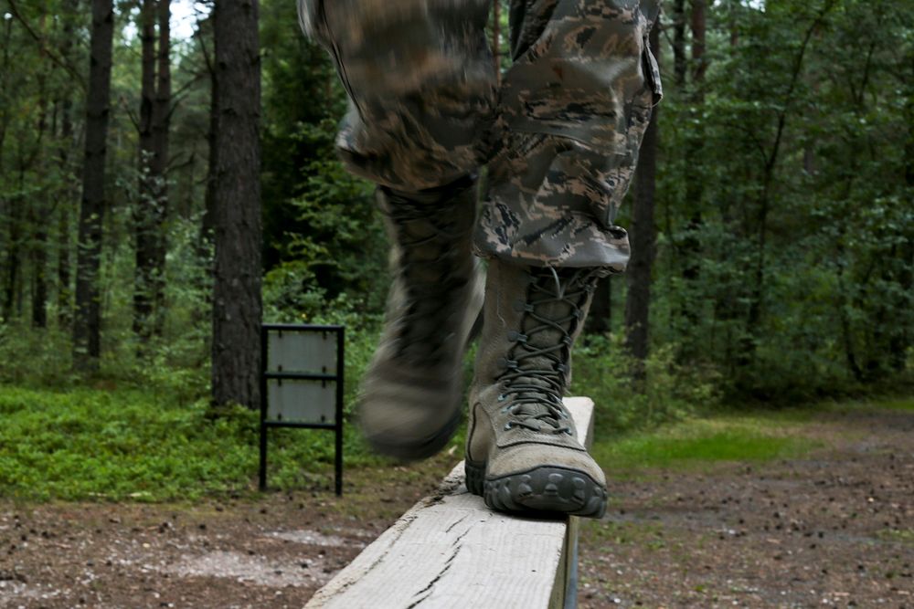 U.S. Air Force Staff Sgt. Alison Jones walks the balance beam on an Obstacle Course at Grafenwoehr Training Area in Bavaria…