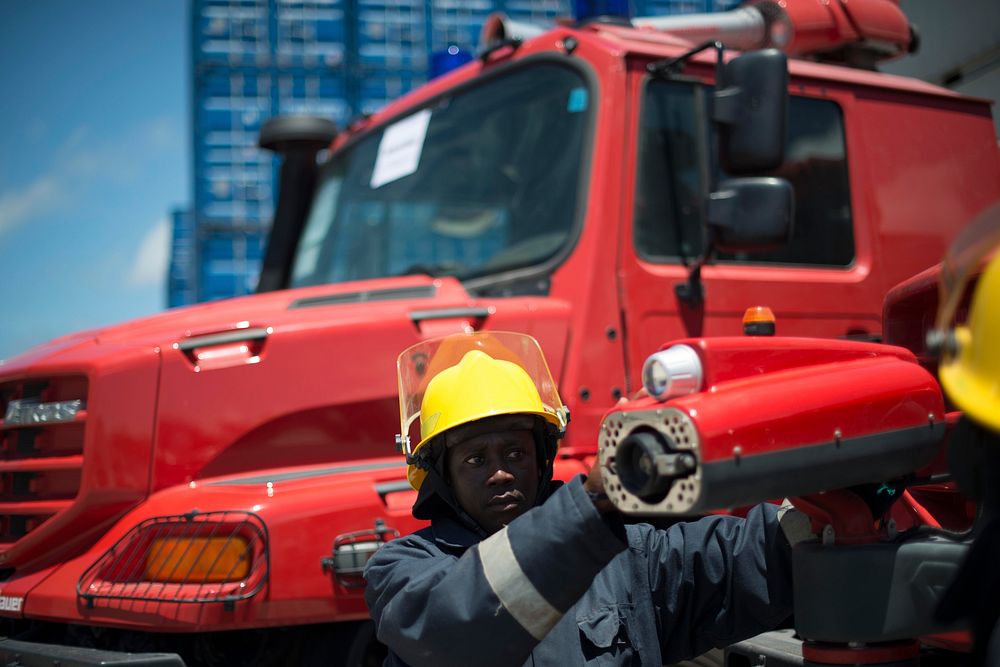A fireman checks on a front hose of a firetruck during a handover of 8 fire trucks by UNSOA to the Federal Government of…