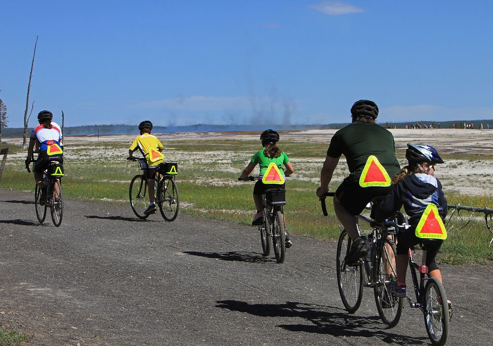 Bicyclists on Fountain Freight Road trail next to Midway Geyser Basin by Jim Peaco. Original public domain image from Flickr