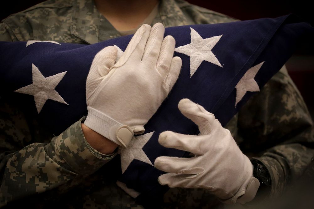 A U.S. Army Soldier from the New Jersey National Guard's Honor Guard holds a folded flag during training at the…