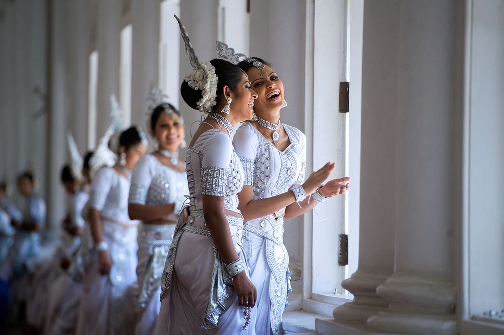 Two Women in Traditional Kandyan Dress Laugh While Waiting as Secretary Kerry Meets With Sri Lankan Foreign Minister…