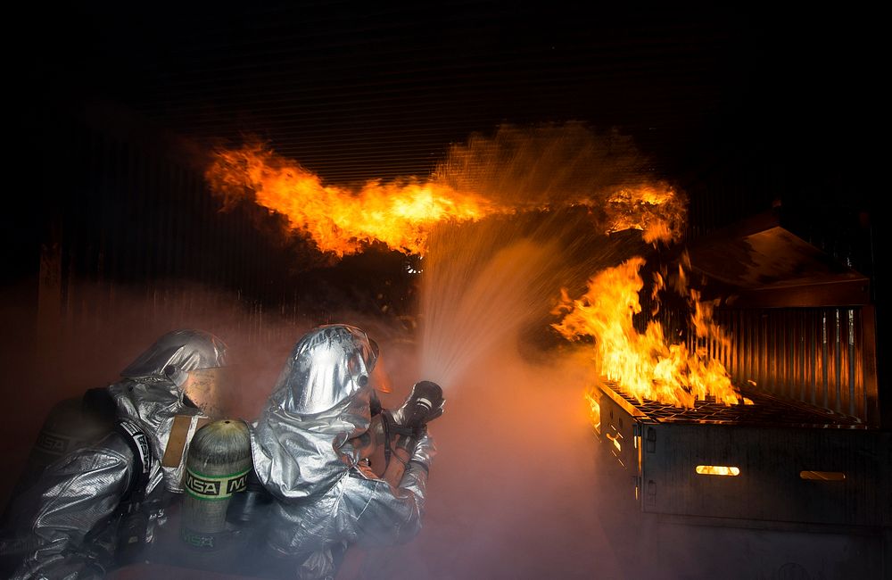 U.S. Air Force firefighters fight flames during a controlled building fire exercise at Ramstein Air Base, Germany on Mar.…
