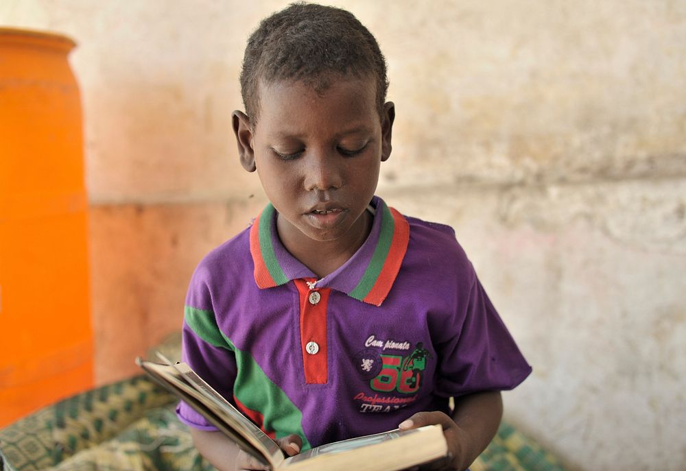A young boy reads the holy Quran in his class at the Somali Orphans and Homeless Children's Center in the Capital Mogadishu…