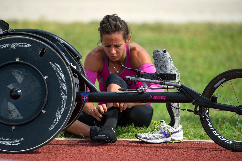 Army Capt. Kelly Elminger prepares her stocking for her lower-leg prosthetic at Joint Base San Antonio June 11, 2015 while…