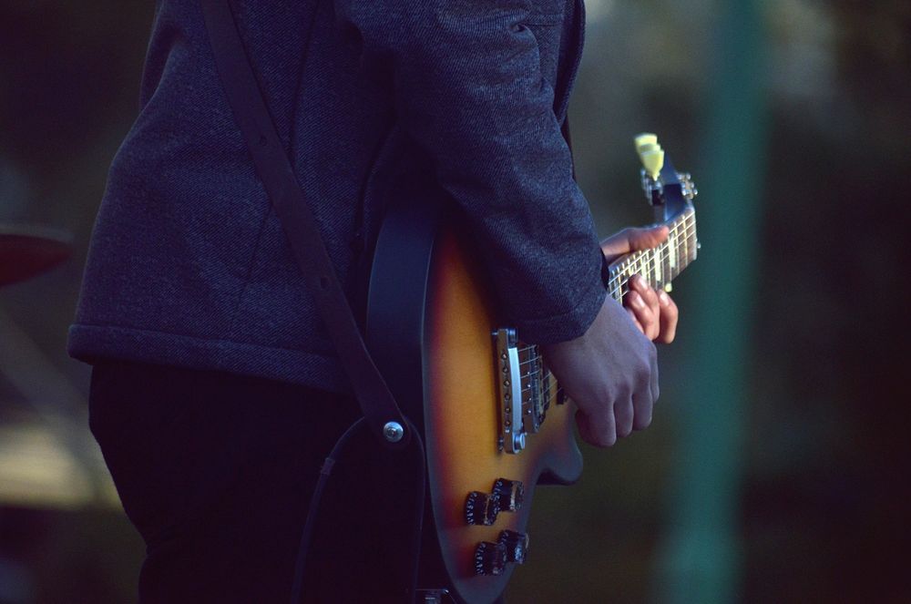 Musician playing guitar, music background.Free public domain CC0 photo.