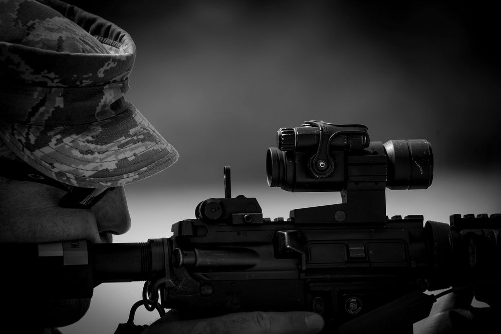 Tech. Sgt. Andrew Hambleton from the New Jersey Air National Guard's 177th Security Forces Squadron adjusts his sights…