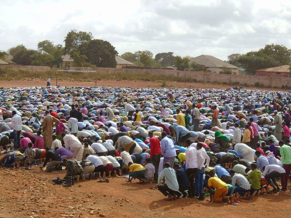 Residents of Baidoa pray at the stadium during the celebrations to mark Eid Al-Fitri in Somalia. Original public domain…