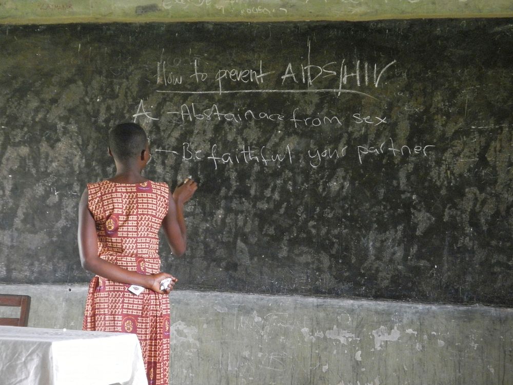 African teacher educating about AIDS. Free public domain CC0 photo.