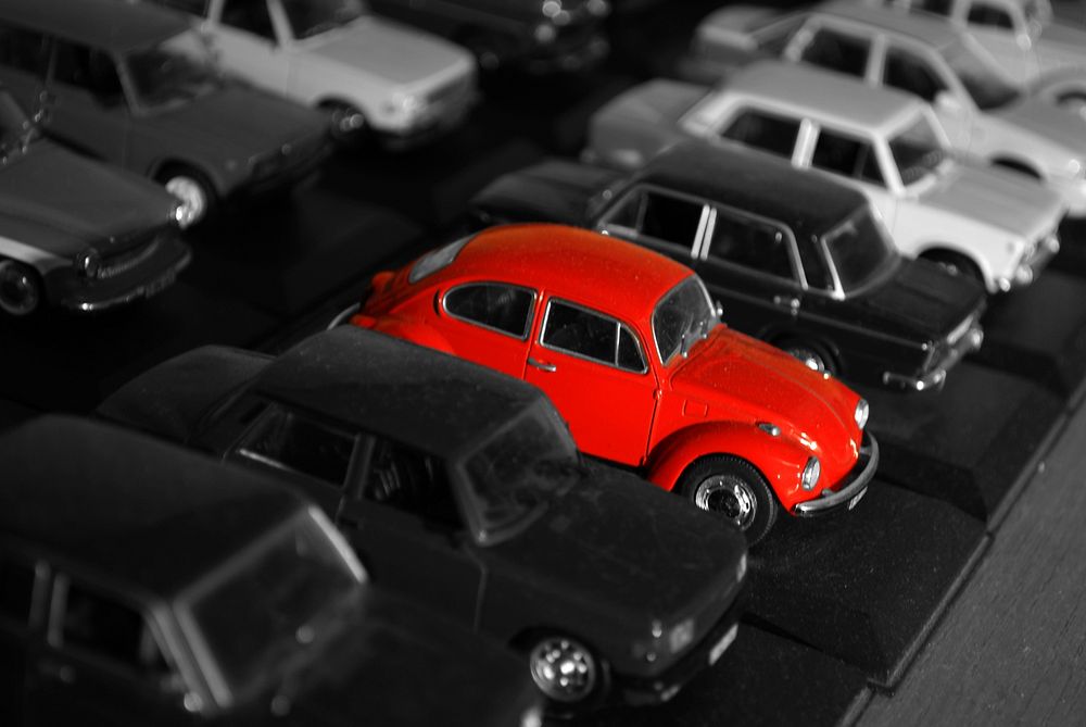 Red Collectible Toy Model Car Volkswagen Beetle on a Black and White Background.