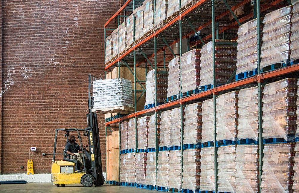 City Harvest Lead Distribution Center Associate Kareem Weekes moving baby food with a forklift before U.S. Department of…