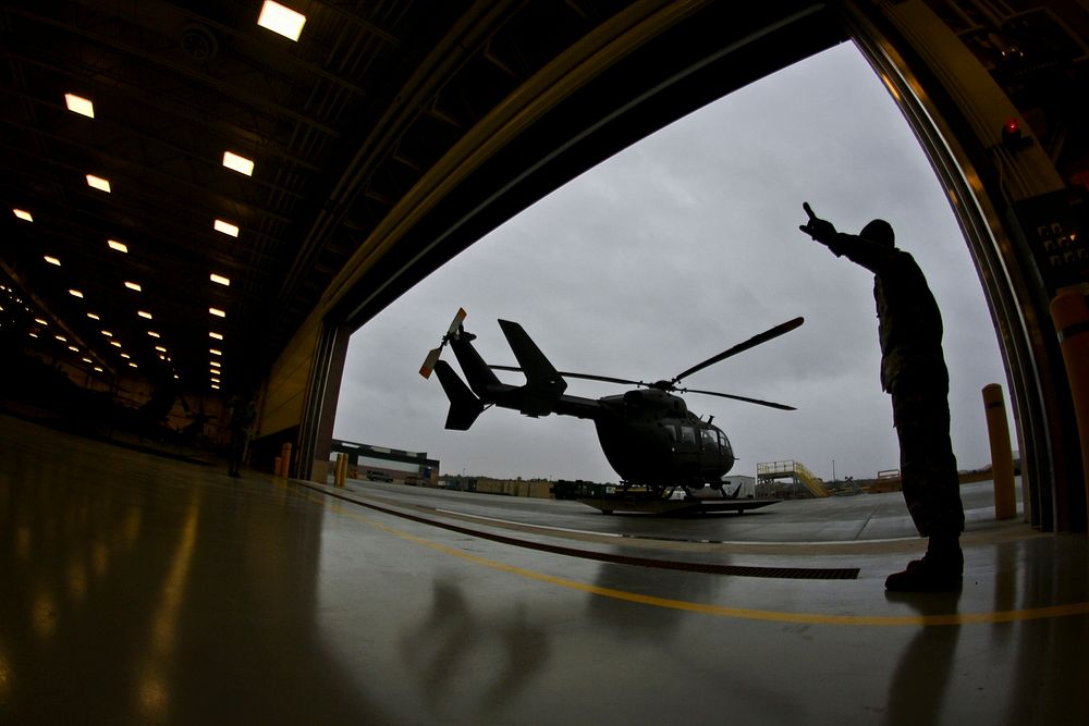 A U.S. Army Soldier with the New Jersey Army National Guard marshalls a UH-72 Lakota helicopter into the Army Aviation…