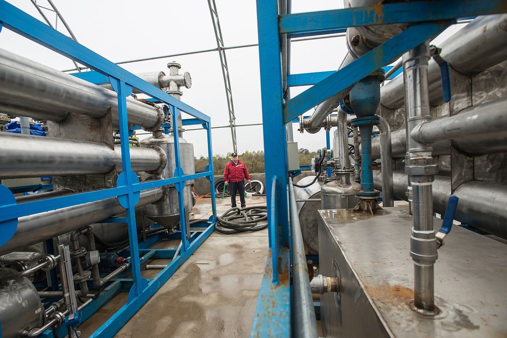 Weeks from completion, a methane reactor with endothermic gasifier surrounds Doug Jernigan, a three-generation family farm…