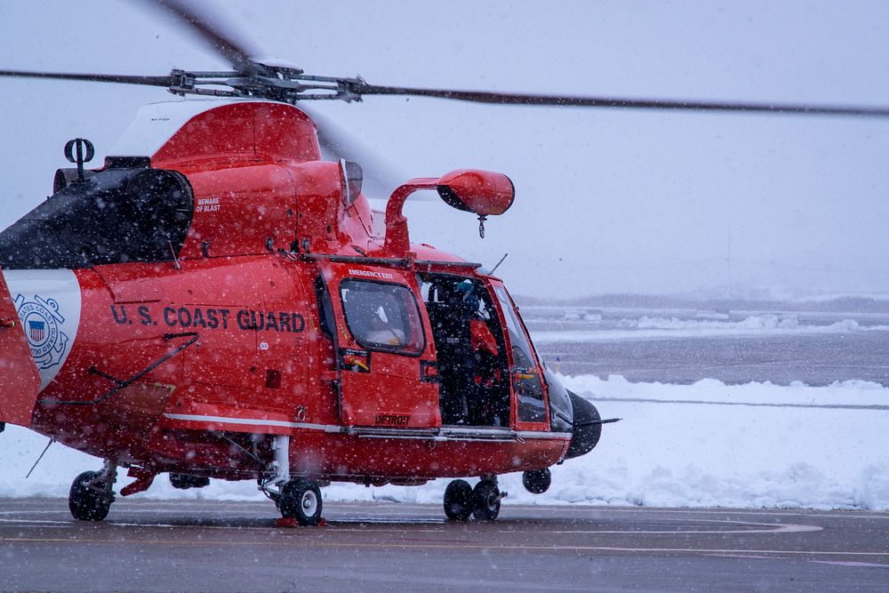 A Coast Guard Air Station Detroit flight crew, aboard an MH-65 Dolphin helicopter, run through post flight checks at…