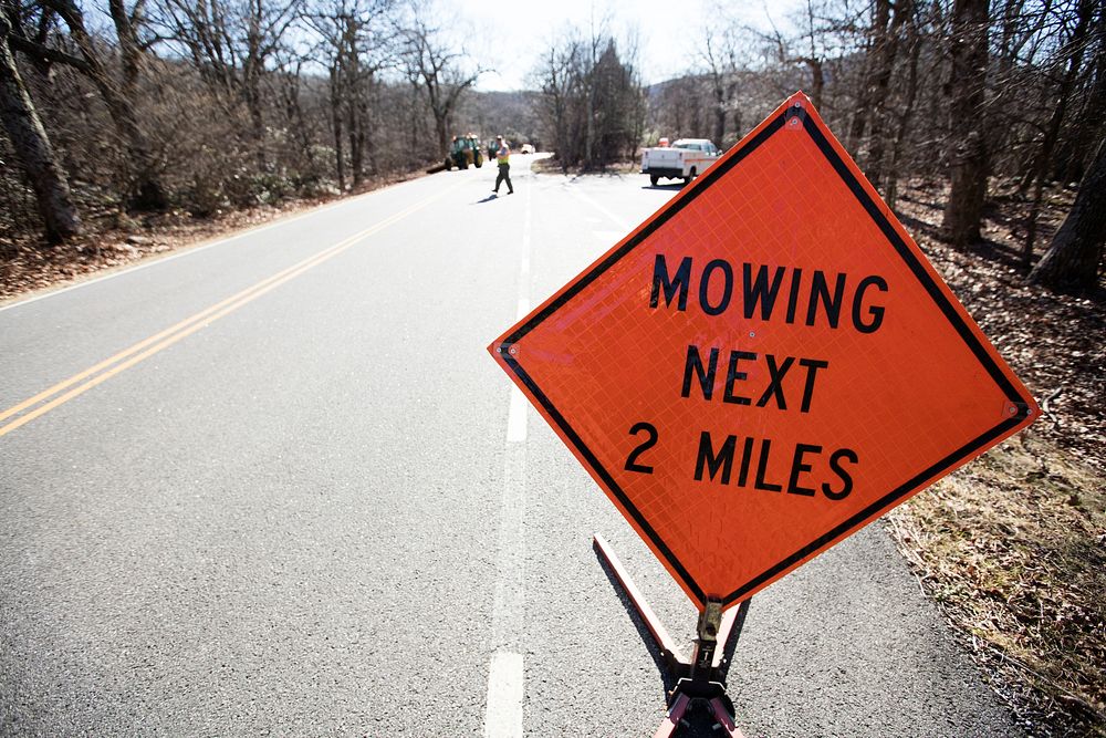 Mowing next 2 miles, traffic construction sign. Free public domain CC0 photo.