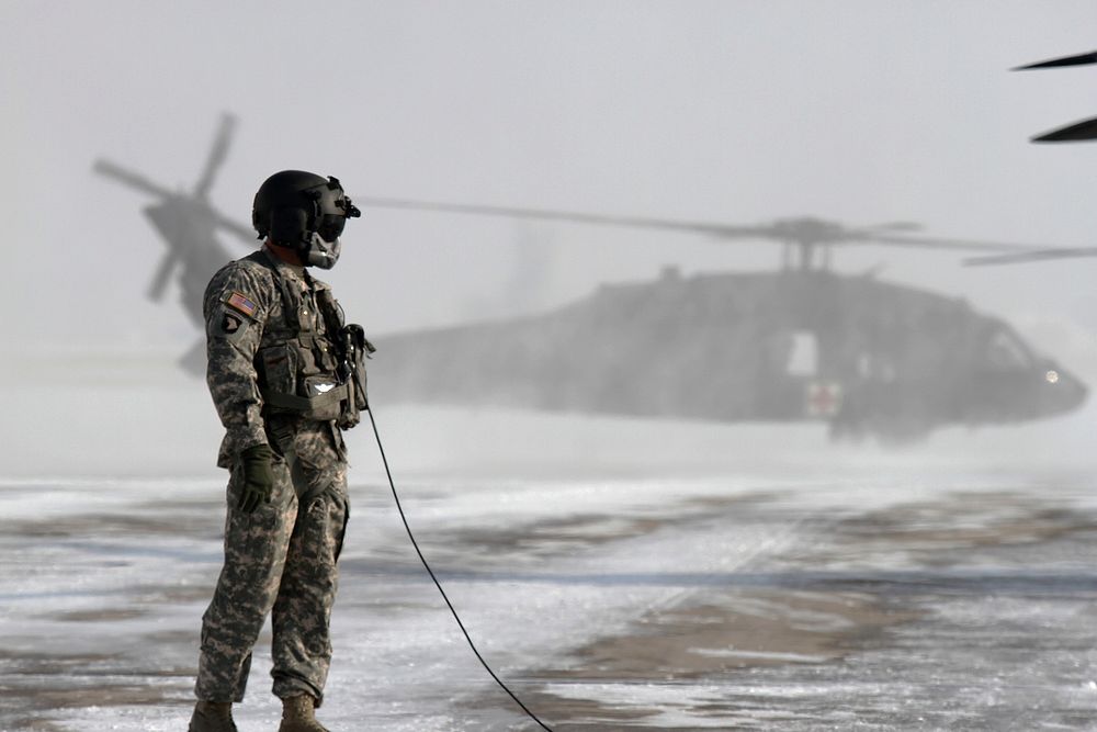 U.S. Army Crew Chief, from the Colorado Army National Guard, conducts preflight checks on a UH-60 Black Hawk helicopter in…