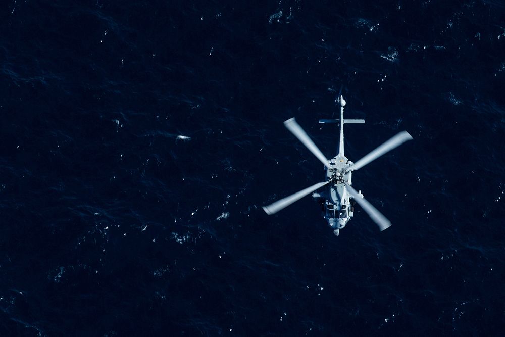 A U.S. Navy MH-60S Seahawk with Helicopter Sea Combat Squadron (HSC) 28, Detachment 4, flies above the Atlantic Ocean during…