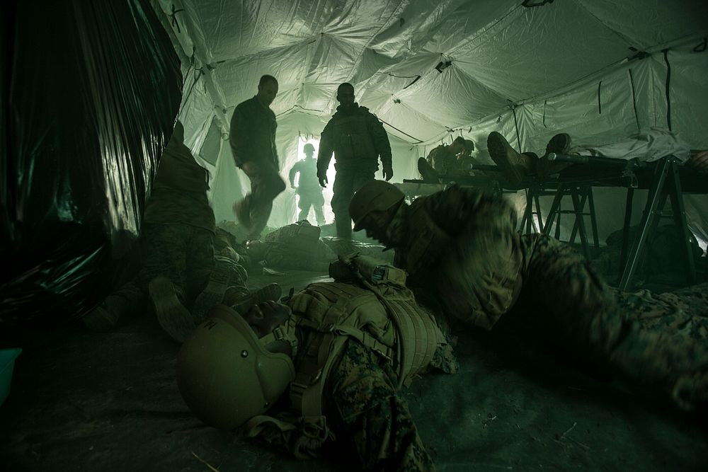 U.S. Navy Corpsmen assigned to Field Medical Training Battalion East (FMTB-E), simulate a mass casualty scenario during a…