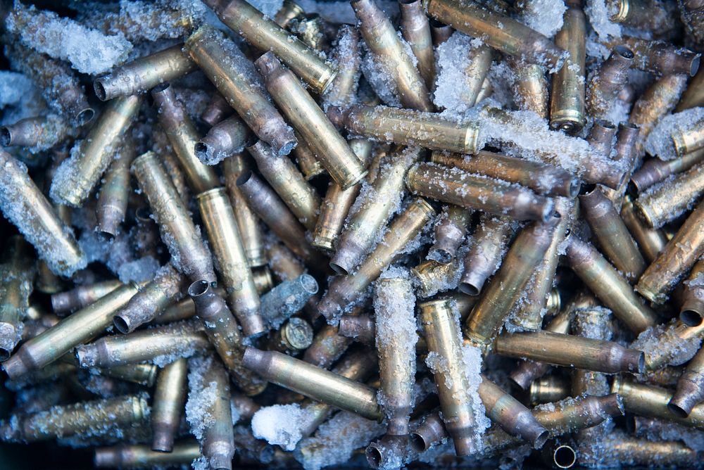 Spent 5.56 mm ammunition casings are collected during small-arms live-fire sustainment training at Joint Base Elmendorf…