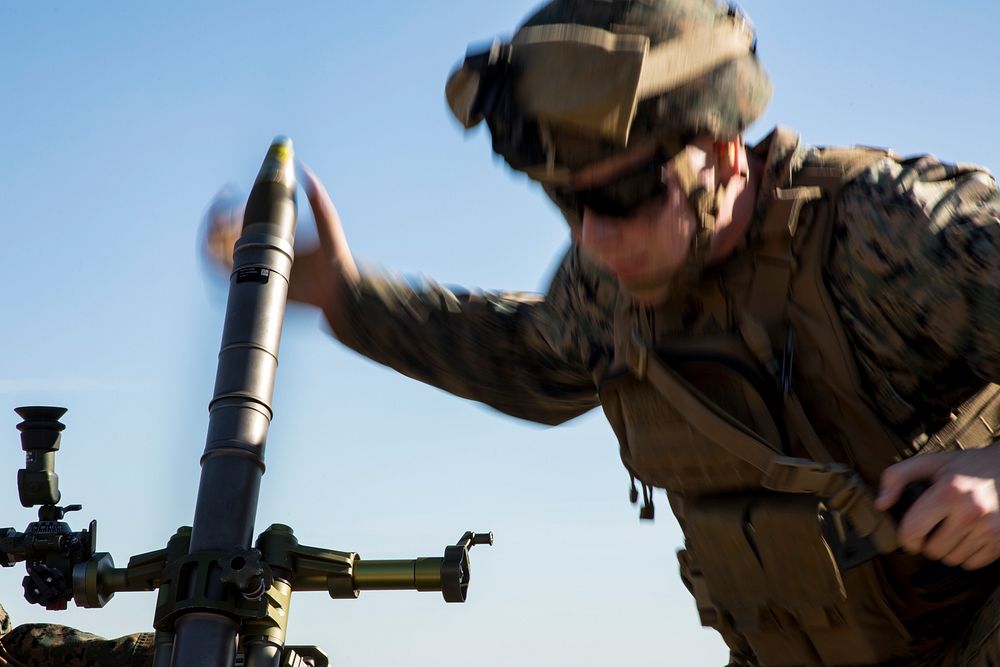 U.S. Marine Corps Lance Cpl. Dylan Sheperd, an assistant gunner, loads a round into an M224 60mm mortar system during a live…