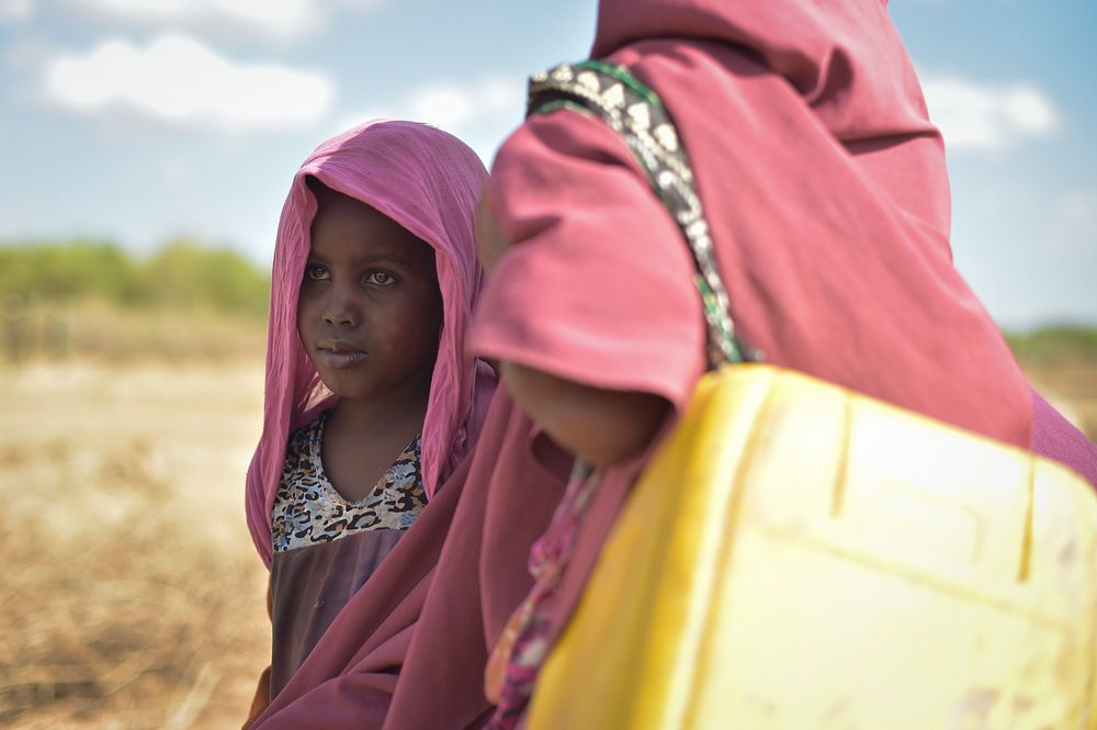 A young girl stands next to her mother in Mahaday, Somalia, on March 3. Mahaday is currently under the control of the…
