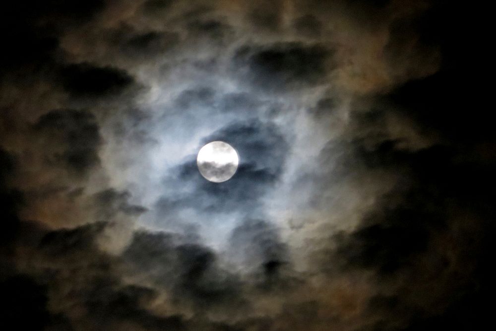 Full moon in cloudy sky.