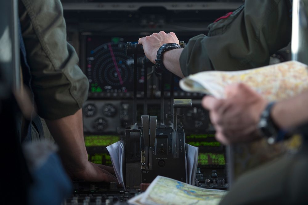 U.S. Air Force pilots assigned to the 517th Airlift Squadron handle controls and maps during a low-level flight for Large…