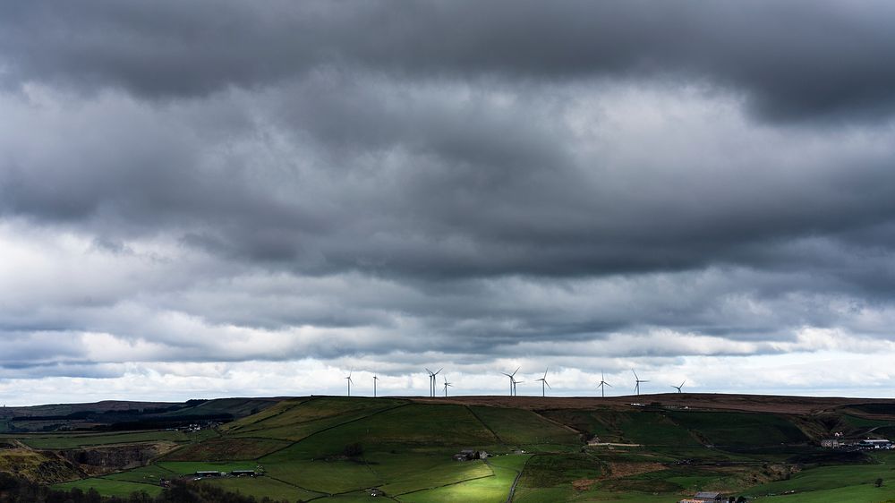 Cloudy sky over wind farm. Original public domain image from Flickr