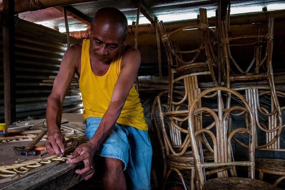 Man making a rattan furniture, Palawan, Philippines, July 2017.