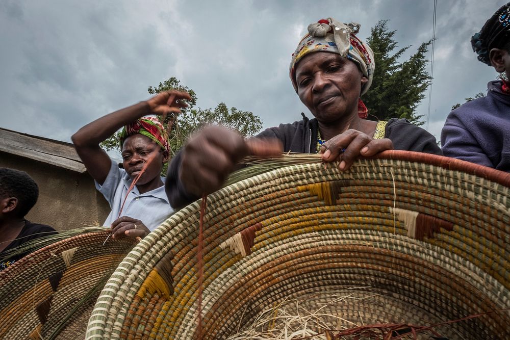 Women artisans weaving traditional baskets, Nkuringo, Uganda. September 2017.