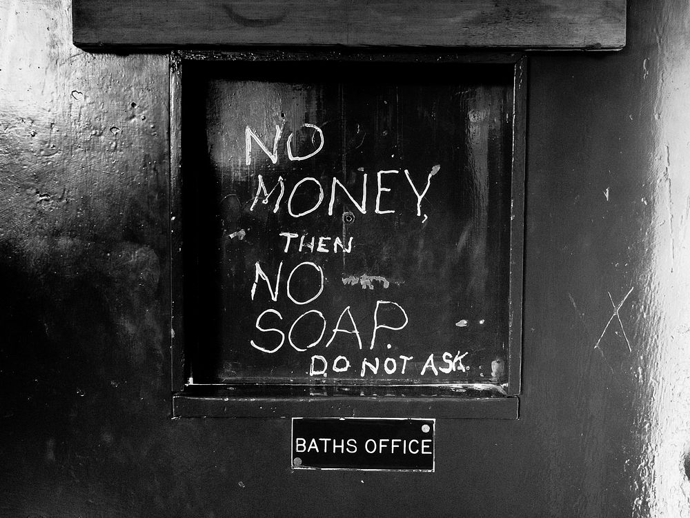 No money the no soap sign wrote on bath office door. Original public domain image from Flickr