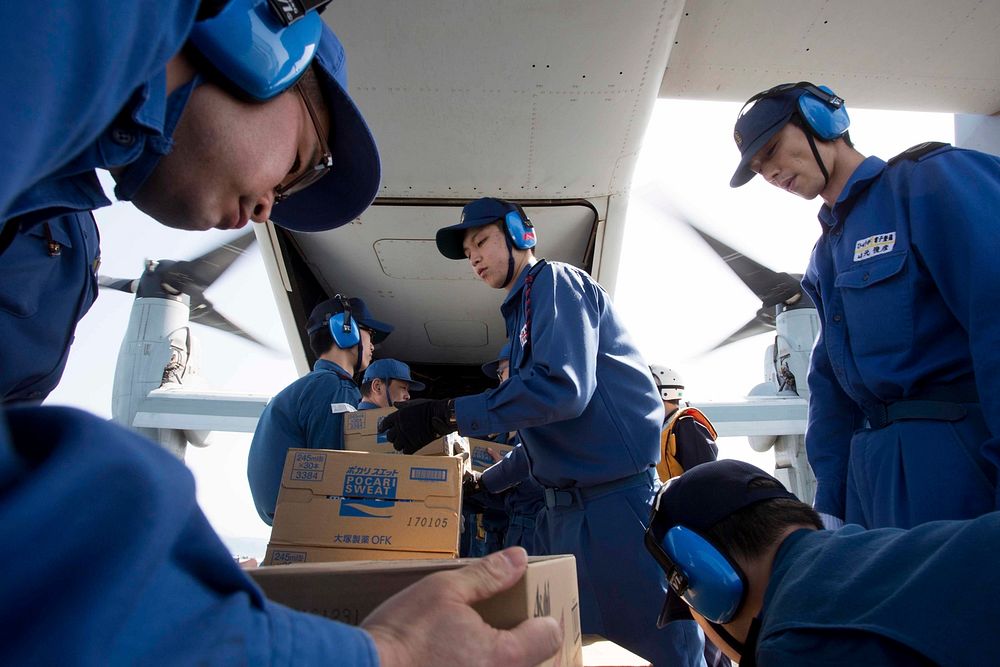 Japan Maritime Self Defense Force personnel load supplies onto a U.S. Marine Corps MV-22B Osprey tiltrotor aircraft assigned…