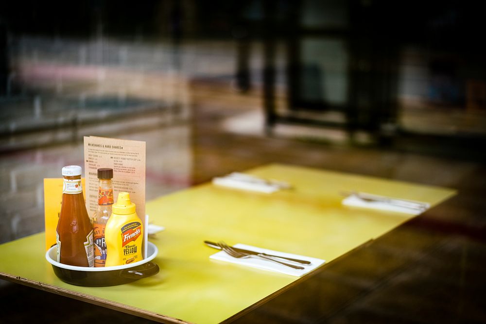 Yellow dining table in a diner. Original public domain image from Flickr