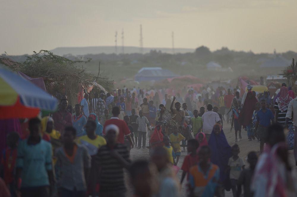 People walk through an IDP camp near the town of Beletweyne, Somalia. Original public domain image from Flickr