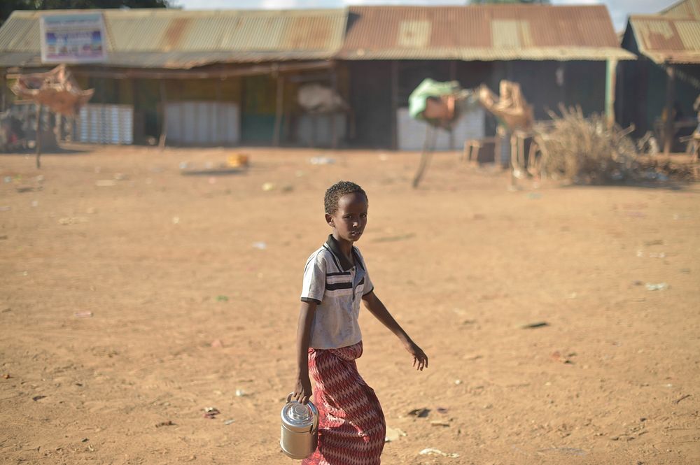 A young boy walks through the streets of Biyo Adde, Somalia, in the early morning of March 7. The town of Biyo Adde was…