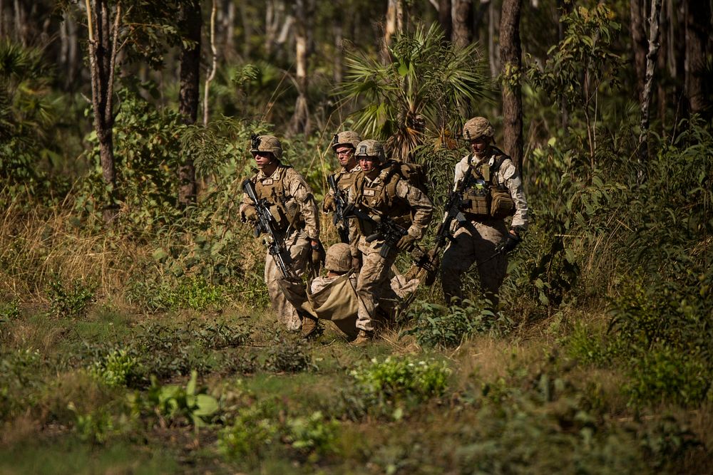 U.S. Marines move a simulated casualty onto a landing zone outside of Robertson Barracks, Northern Territory, Australia, May…