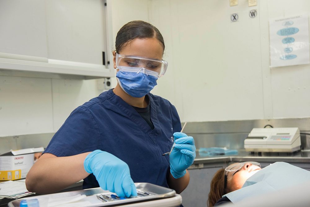 MEDITERRANEAN SEA (June 29, 2016) &ndash; Hospitalman Rachel Folwell begins a dental cleaning on Legalman 1st Class Renae…