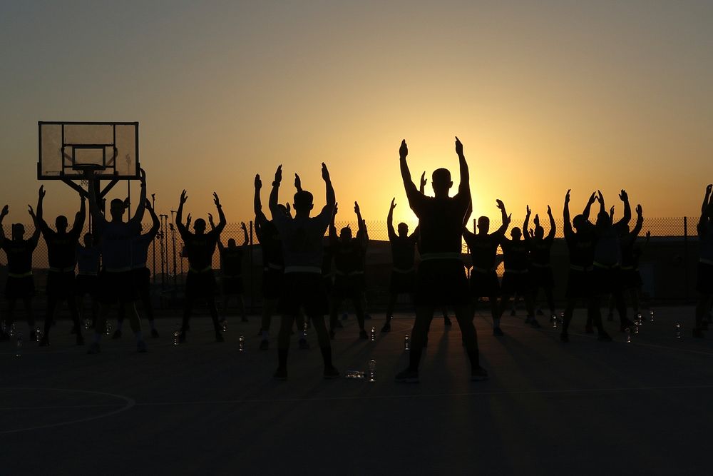 U.S Soldiers assigned to the 56th Signal Company stretch before an early morning run at Camp Arifjan, Kuwait, June 13, 2016.…
