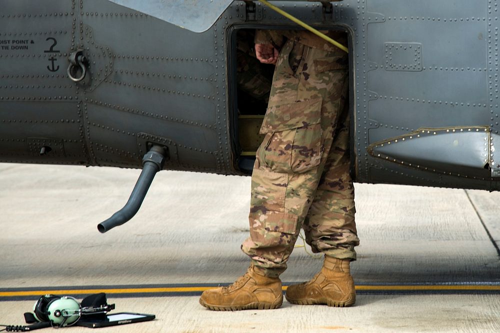 U.S. Air Force Senior Airman Kaiden Stanley, assigned to the 41st Helicopter Maintenance Unit, reviews component locations…