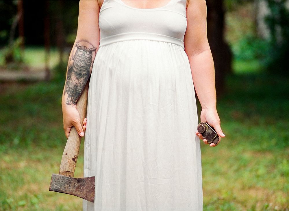Tattooed bride with axe. Free public domain CC0 photo.